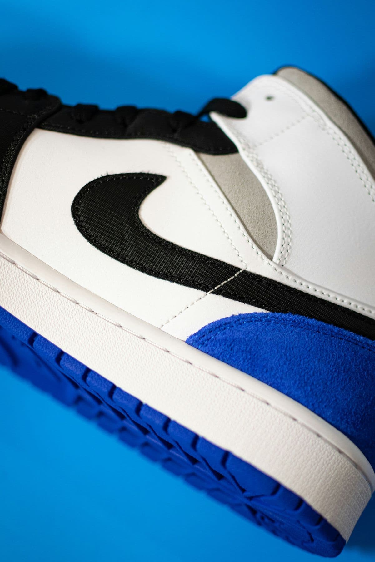 Close-up of an Air Jordan 1 in white, black and royal blue