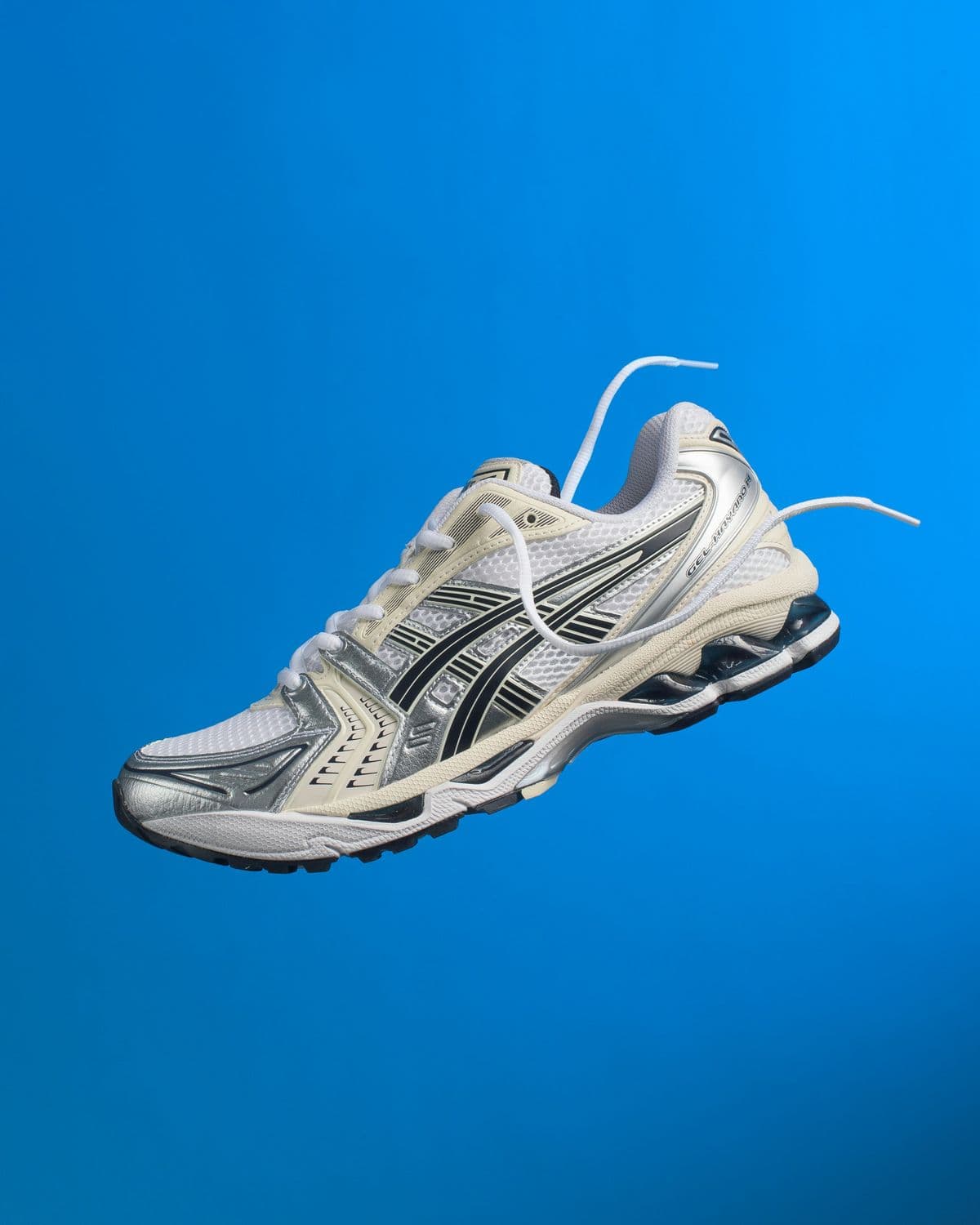 ASICS running shoe floating against a blue background