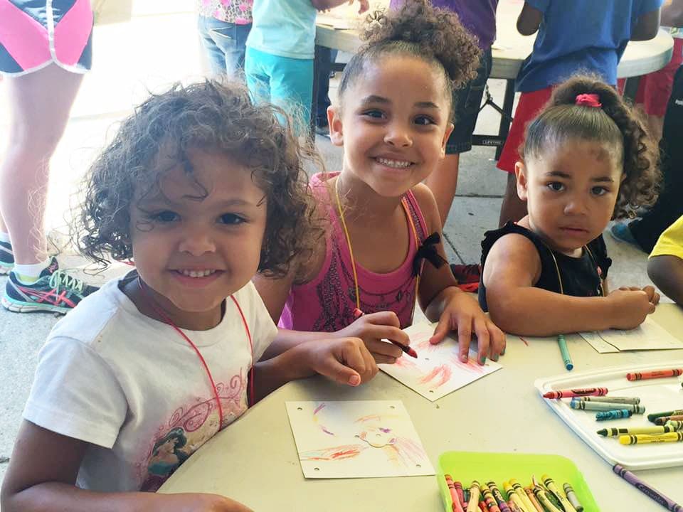 Young girls coloring at a table
