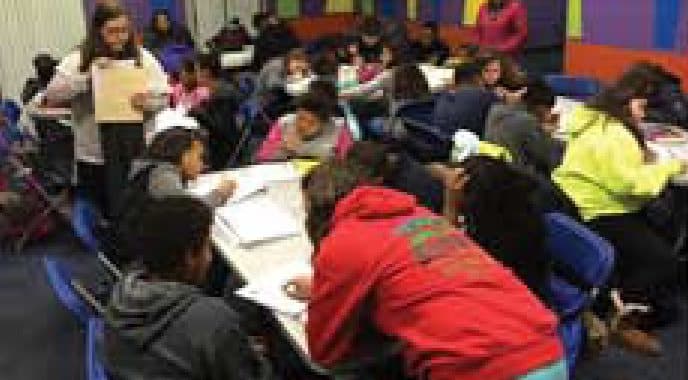 Students working at tables during a study session