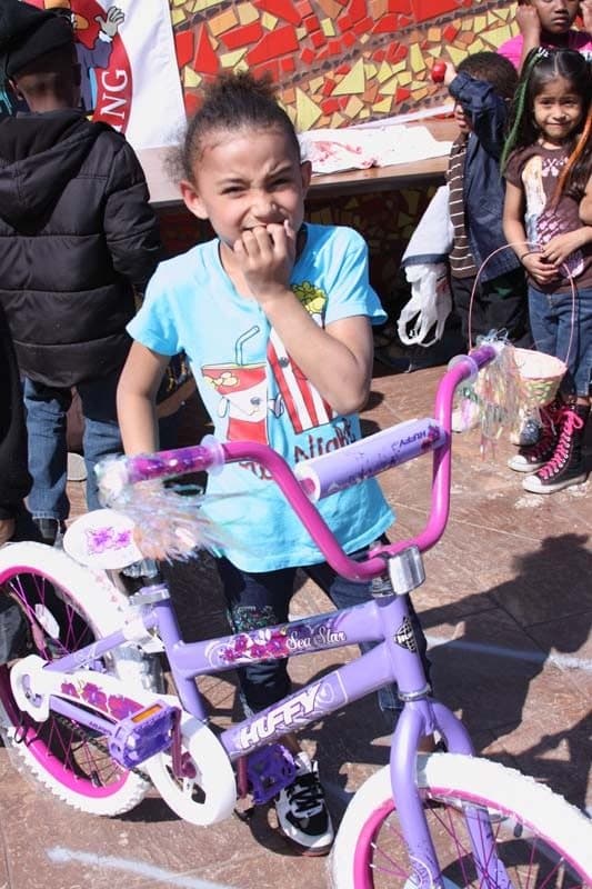 A girl with her new purple bike