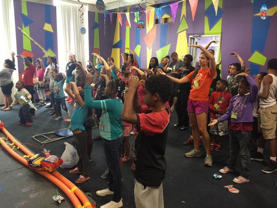 Kids dancing and playing at an indoor event