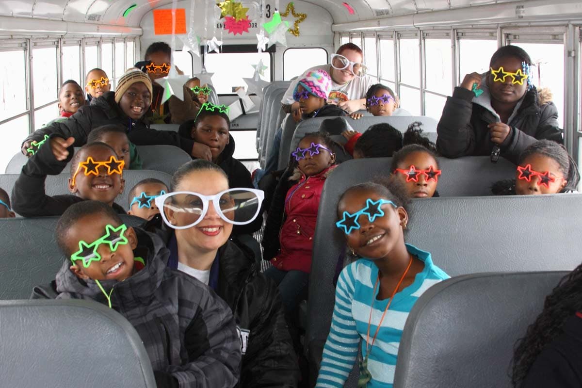 Kids in fun glasses on a school bus