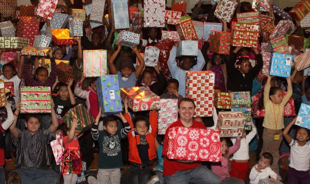 Kids cheering with presents raised high