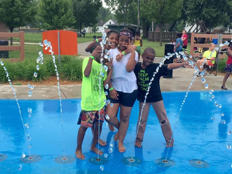 Kids playing at a splash pad in the summer